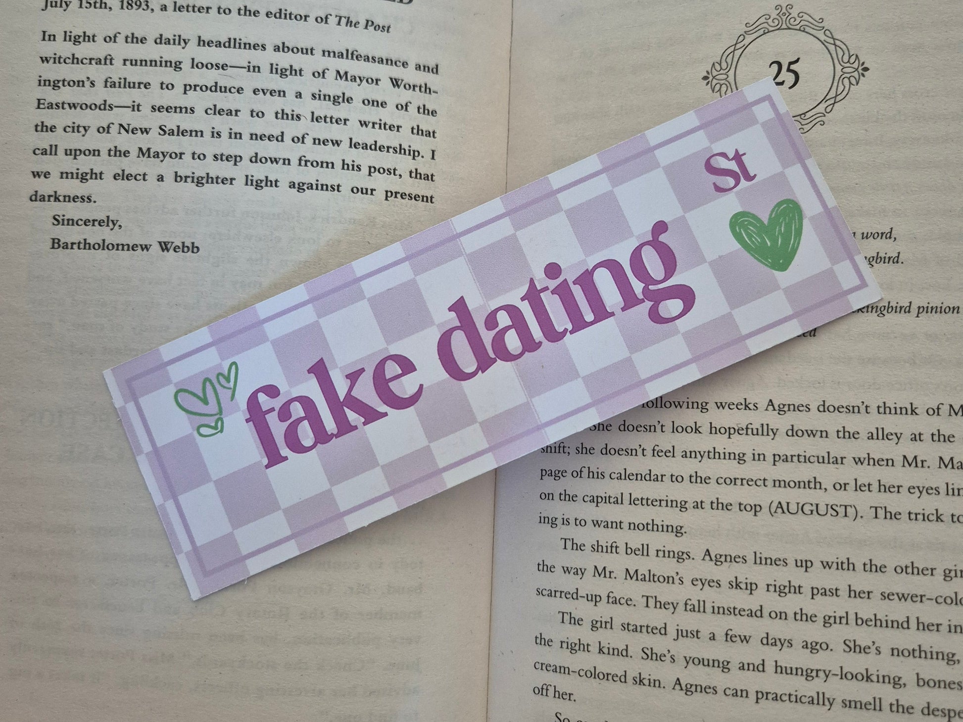 Chequered bookmark with the words 'fake dating street' placed on an open book